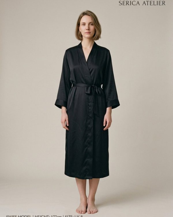 Model wearing a floor-length black silk kimono robe with a tied belt